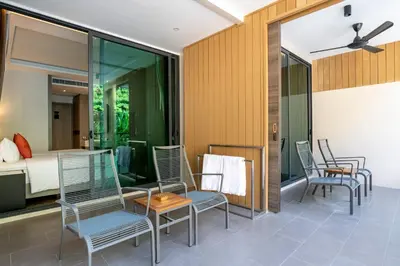 a room with chairs and a bed and a bedroom at SKYVIEW Resort Phuket Patong Beach in Patong Beach
