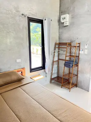 a bedroom with a bed and a window at Green Mountain Resort Koh Yao in Ko Yao Yai