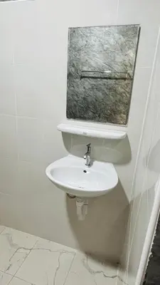 a bathroom with a white sink and a window at Green Mountain Resort Koh Yao in Ko Yao Yai