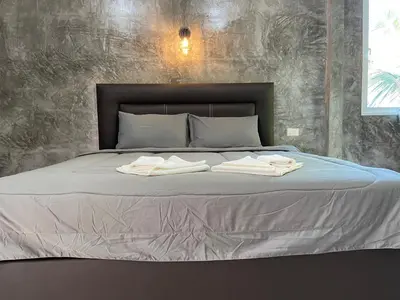 a bed with two towels on top of it at Green Mountain Resort Koh Yao in Ko Yao Yai