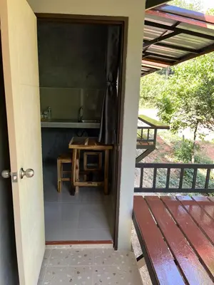 an open door to a porch with a table at Green Mountain Resort Koh Yao in Ko Yao Yai