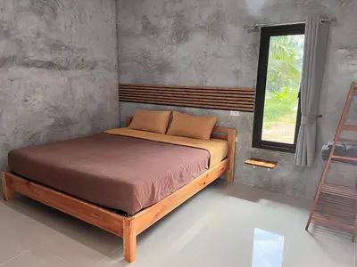 a bed in a room with a window at Green Mountain Resort Koh Yao in Ko Yao Yai