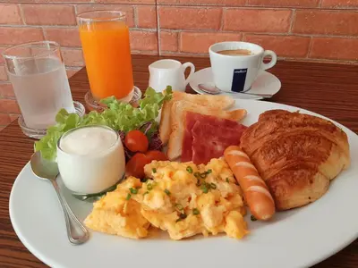 a plate of breakfast food with eggs bread and toast at GN Capsule Hostel Patong in Patong Beach
