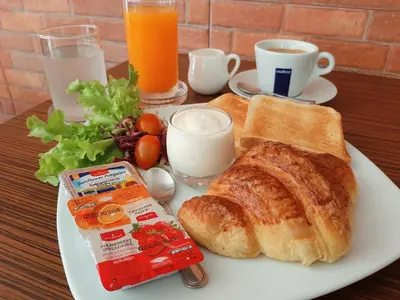a plate of breakfast food with bread and toast at GN Capsule Hostel Patong in Patong Beach