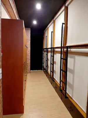 a hallway with doors and windows in a building at GN Capsule Hostel Patong in Patong Beach