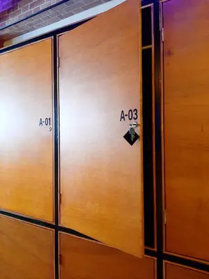 a pair of wooden doors with numbers on them at GN Capsule Hostel Patong in Patong Beach