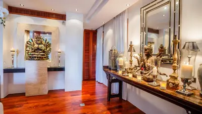 a room with a counter with vases and a mirror at Villa in the Garden, Surin Beach with private spa. in Surin Beach