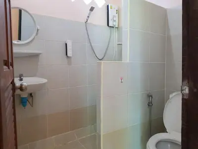 a bathroom with a shower with a toilet and a sink at Discovery House Hotel SHA Plus in Nai Yang Beach