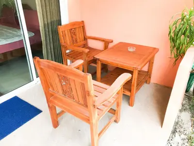 a table and two chairs and a table and a table and a table and chairs at Discovery House Hotel SHA Plus in Nai Yang Beach