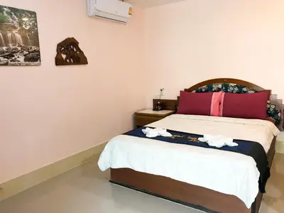 a bedroom with a bed with towels on it at Discovery House Hotel SHA Plus in Nai Yang Beach