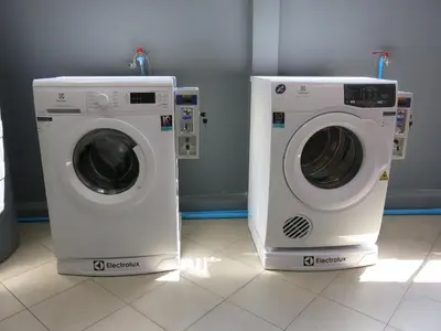 two washing machines sitting next to each other in a room at Niece Hostel Phuket - Bangtao Beach in Ban Thalat Choeng Thale