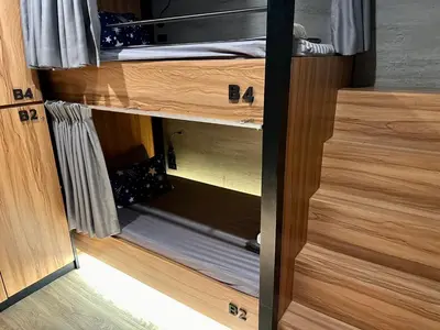 a wooden cupboard with ajarartments of a room at Niece Hostel Phuket - Bangtao Beach in Ban Thalat Choeng Thale