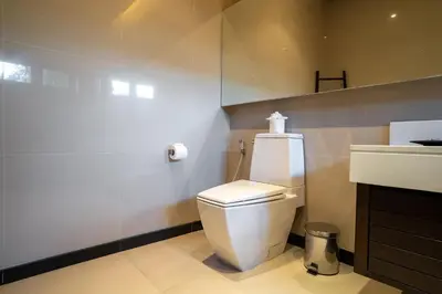 a bathroom with a white toilet and a sink at The Harmony Pool Villa Phuket in Bang Tao Beach