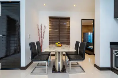 a dining room with a table and chairs at The Harmony Pool Villa Phuket in Bang Tao Beach