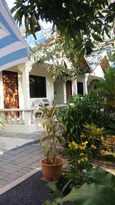 a house with a lot of plants in front of it at Wattana Bungalow in Nai Yang Beach