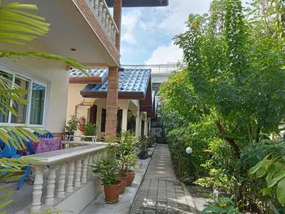 a house with a walkway in front of it at Wattana Bungalow in Nai Yang Beach