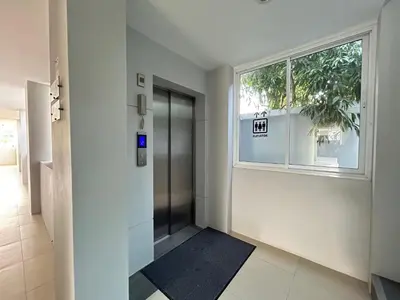 an empty hallway with a door and a window at Clear House Resort - SHA Extra Plus in Kamala Beach