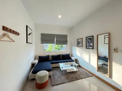 a living room with a couch and a mirror at Clear House Resort - SHA Extra Plus in Kamala Beach