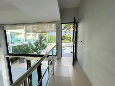 a hallway of a house with a glass door at Clear House Resort - SHA Extra Plus in Kamala Beach