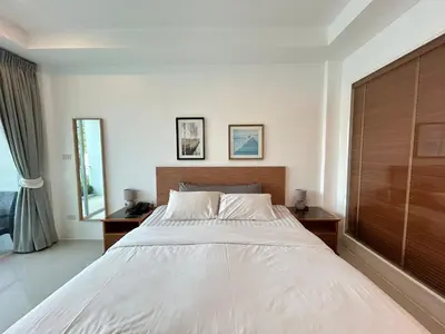 a bedroom with a large white bed and a window at Clear House Resort - SHA Extra Plus in Kamala Beach