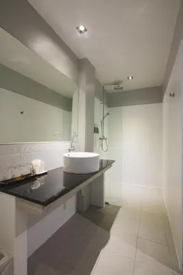 a bathroom with a sink and a mirror at Naina Resort & Spa - SHA Extra Plus in Patong Beach