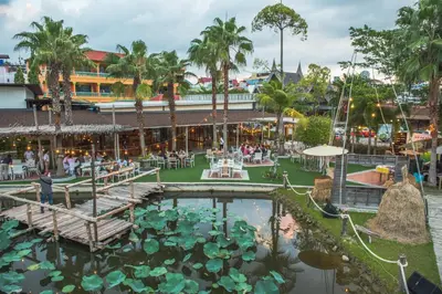 a large pond with lilies in a park at Naina Resort & Spa - SHA Extra Plus in Patong Beach