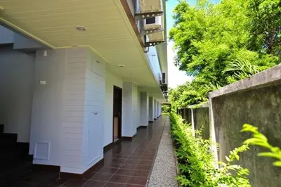 a hallway of a building with a walk way at Chalong Beach Front Residence in Rawai Beach