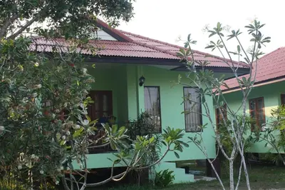 a green house with a pink roof at Anacar Bungalows in Krabi town