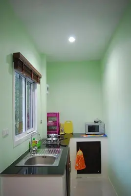 a kitchen with a sink and a microwave at Anacar Bungalows in Krabi town