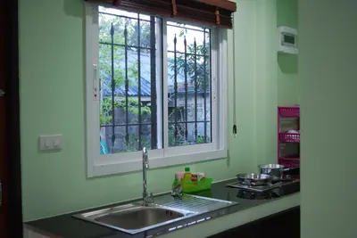 a kitchen with a sink and a window at Anacar Bungalows in Krabi town