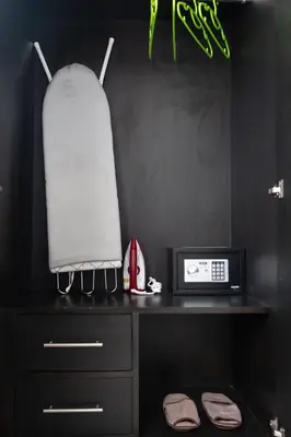 a room with a desk with a microwave and a clock at May House Karon Beach in Karon Beach