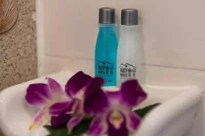 a purple flower sitting next to a bottle of soap at May House Karon Beach in Karon Beach