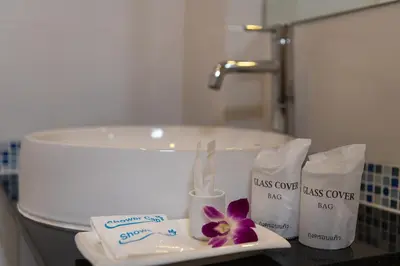a bathroom with two complimentary towels and a sink at May House Karon Beach in Karon Beach