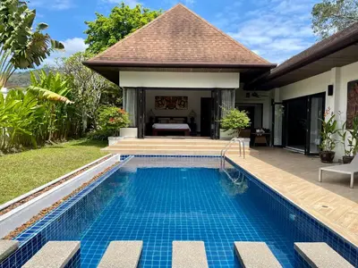 a swimming pool in the backyard of a villa at Villa Suksan - Kubu in Nai Harn Beach