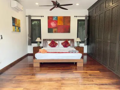 a bedroom with a bed and a ceiling fan at Villa Suksan - Kubu in Nai Harn Beach