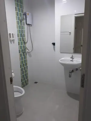 a bathroom with a shower and a toilet and a sink at B&B NAMO PHUKET in Kathu