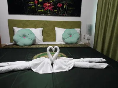 a bedroom with a bed with towels on it at B&B NAMO PHUKET in Kathu