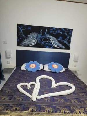 a bedroom with a bed with two hearts drawn on it at B&B NAMO PHUKET in Kathu