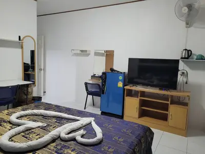 a room with a bed with a hose on it at B&B NAMO PHUKET in Kathu