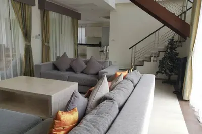 a living room with a couch and a table at 4 Bedroom Villa Kamala Beach Phuket in Kamala Beach