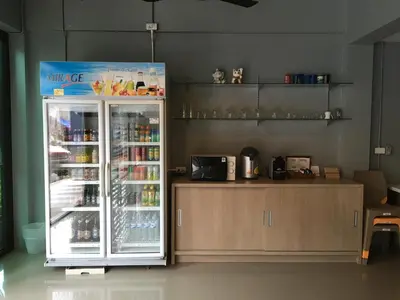 a refrigerator with drinks in it in a room at Chalong Sea Breeze in Chalong