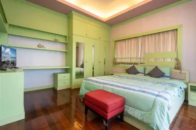 a bedroom with a large bed and a red stool at Phuket Pool Villa Sea view at town in Phuket Town
