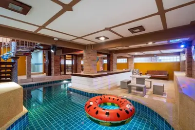 a large swimming pool with a large orange inflatable at Phuket Pool Villa Sea view at town in Phuket Town
