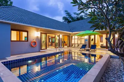 a villa with a swimming pool and a house at Lady Naya Villas - SHA Extra Plus in Rawai Beach