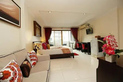 a living room with a couch and a bed at Sky Silk Decoration House in Patong Beach
