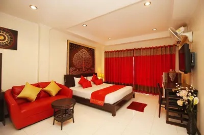 a bedroom with a red bed and a red couch at Sky Silk Decoration House in Patong Beach