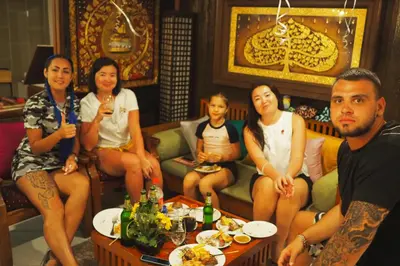 a group of people sitting in a living room at Sky Silk Decoration House in Patong Beach