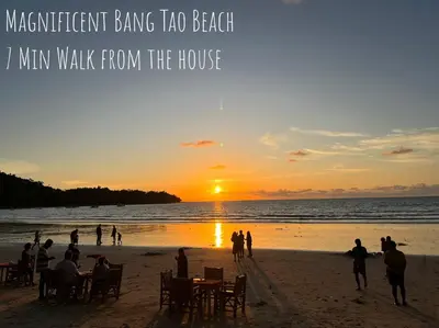a group of people on the beach at sunset at Bangtao Kitchen Studio in Bang Tao Beach
