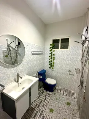 a bathroom with a sink and a toilet and a mirror at Bangtao Kitchen Studio in Bang Tao Beach