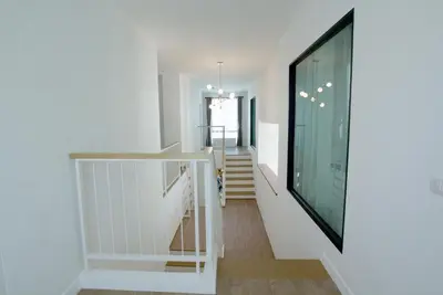a staircase in a house with white walls at Happy Family Villa in Phuket Town